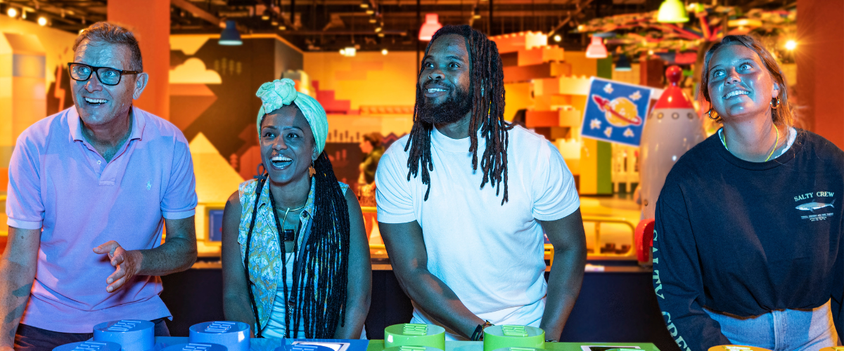 Adults enjoying building LEGO bricks at LEGO Discovery Center Atlanta